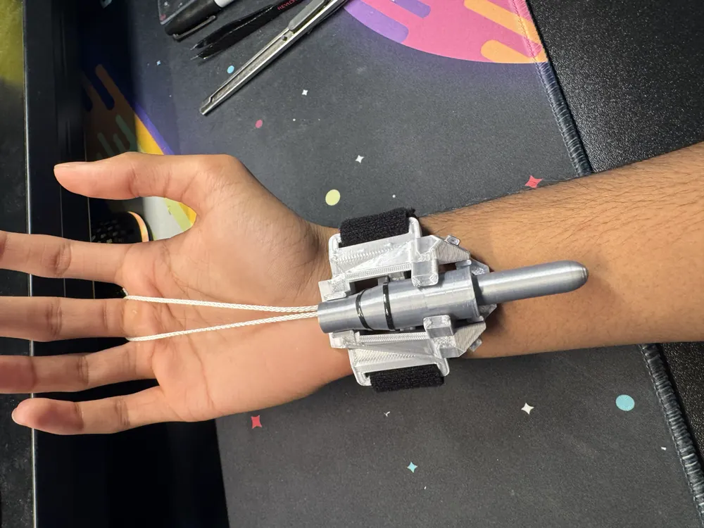 The finished V2 webshooter strapped to a wrist, with the pull strings looped around the fingers.